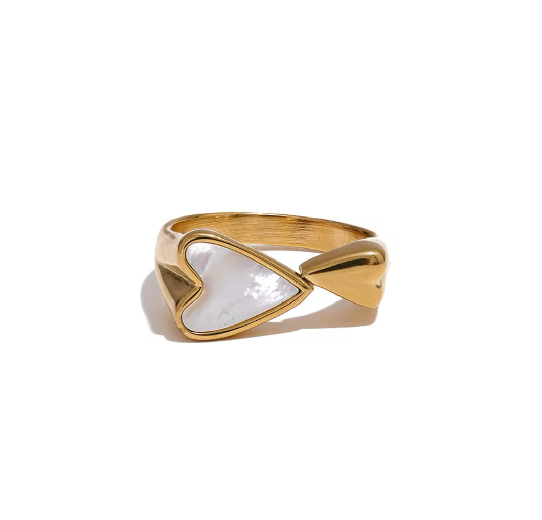 Golden ring with heart-shaped seashells