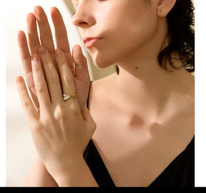 Golden ring with heart-shaped seashells